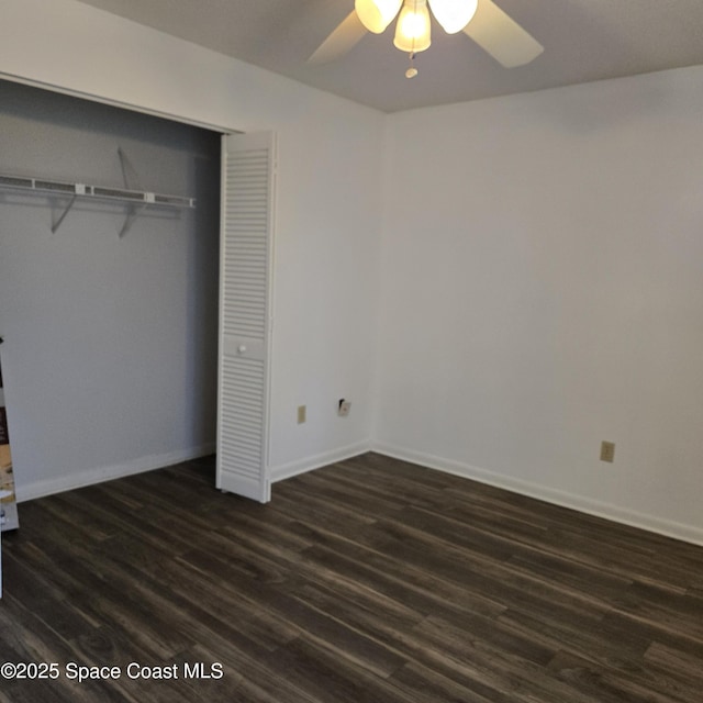 unfurnished bedroom featuring dark hardwood / wood-style floors, ceiling fan, and a closet