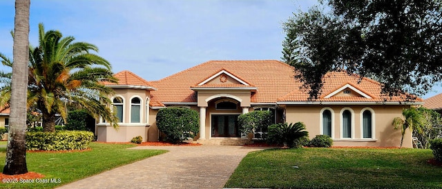 mediterranean / spanish-style home featuring a front lawn