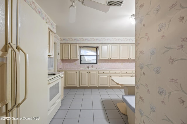 kitchen with sink, white appliances, light tile patterned floors, ceiling fan, and tasteful backsplash