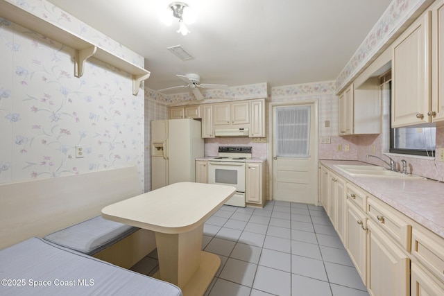 kitchen with sink, tasteful backsplash, white appliances, light tile patterned floors, and ceiling fan