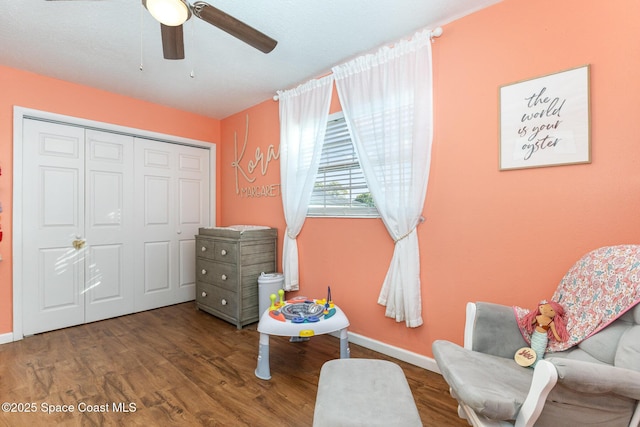 living area with hardwood / wood-style flooring and ceiling fan