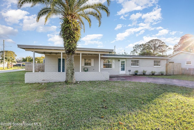 ranch-style home featuring a porch, a front yard, and fence