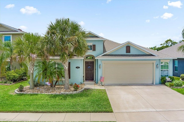 view of front of home featuring a garage and a front lawn