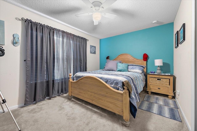 bedroom with a textured ceiling, ceiling fan, and carpet