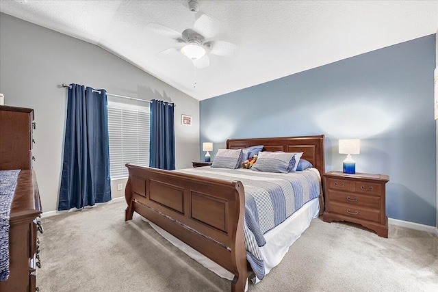 carpeted bedroom with lofted ceiling, a textured ceiling, and ceiling fan