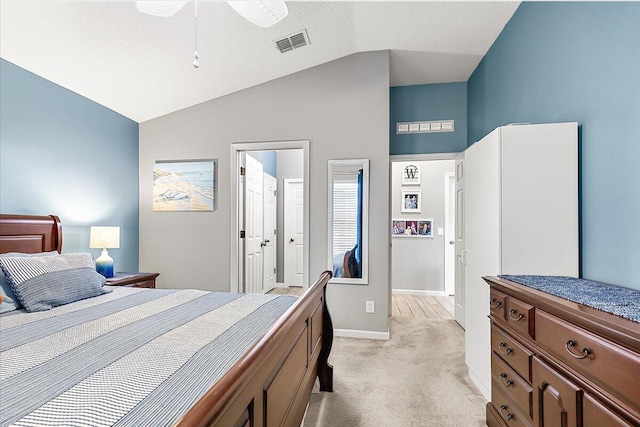 carpeted bedroom featuring vaulted ceiling, ceiling fan, and ensuite bathroom