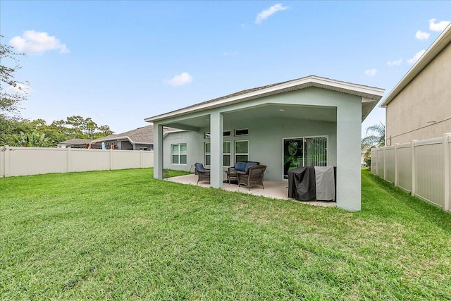 rear view of house featuring a patio and a yard