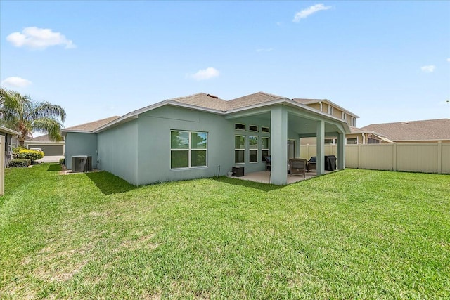 back of property featuring a patio, a yard, and central AC unit