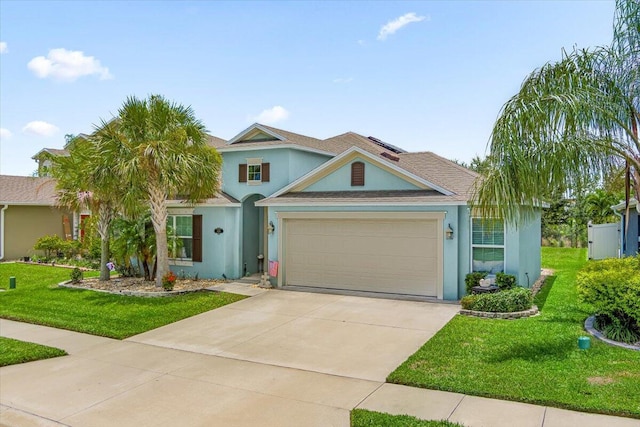 view of front of house with a garage and a front lawn