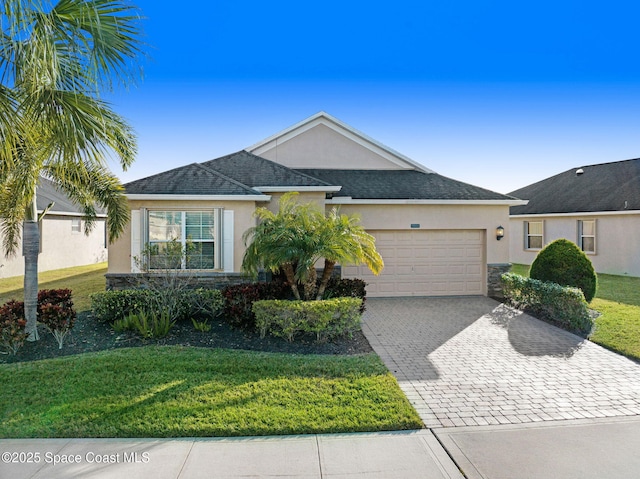 ranch-style house with a garage, stone siding, a front lawn, and stucco siding