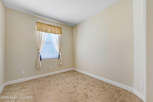 3804 Sansome Cir, Melbourne, FL 32940 - empty room featuring baseboards and light tile patterned flooring