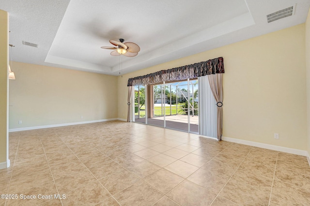 3804 Sansome Cir, Melbourne, FL 32940 - empty room with ceiling fan, tile patterned floors, visible vents, and a raised ceiling