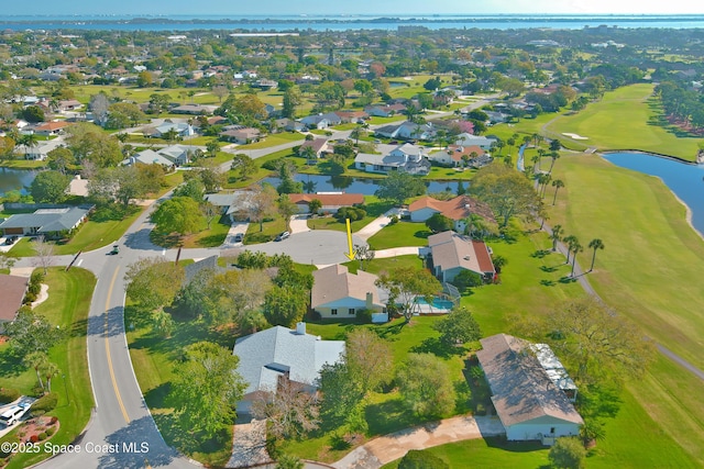 drone / aerial view with a residential view and a water view