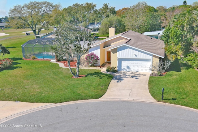 view of front of home with driveway, a chimney, a lanai, an attached garage, and a front lawn