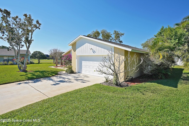 view of side of home featuring driveway, a garage, and a yard