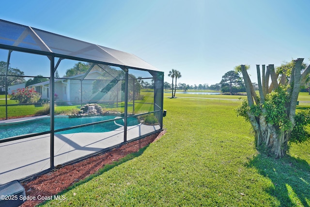 view of yard featuring glass enclosure and an outdoor pool