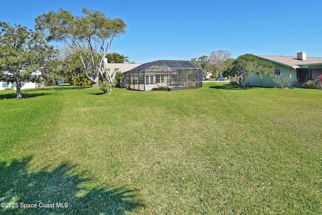 view of yard featuring glass enclosure