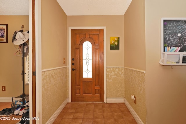 entrance foyer with a wainscoted wall