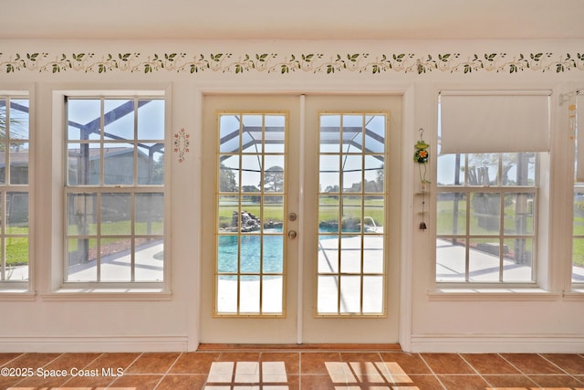 entryway featuring french doors, plenty of natural light, and tile patterned floors