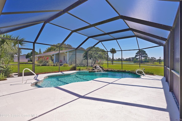 outdoor pool featuring glass enclosure, a patio area, and a yard