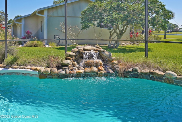 view of swimming pool with a lawn, a lanai, and a fenced in pool