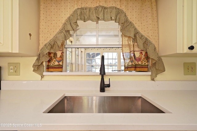 kitchen with light countertops and a sink