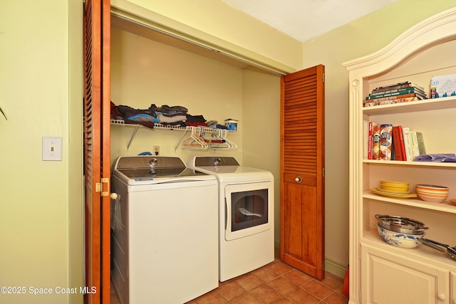 washroom featuring light tile patterned floors, laundry area, and separate washer and dryer