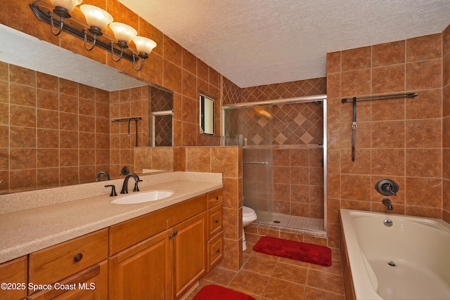 bathroom featuring a stall shower, a textured ceiling, tile walls, and tile patterned floors