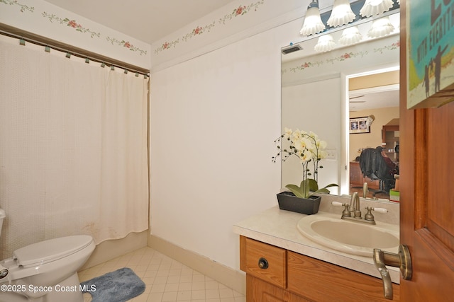 full bath with baseboards, toilet, tile patterned flooring, shower / bath combo with shower curtain, and vanity