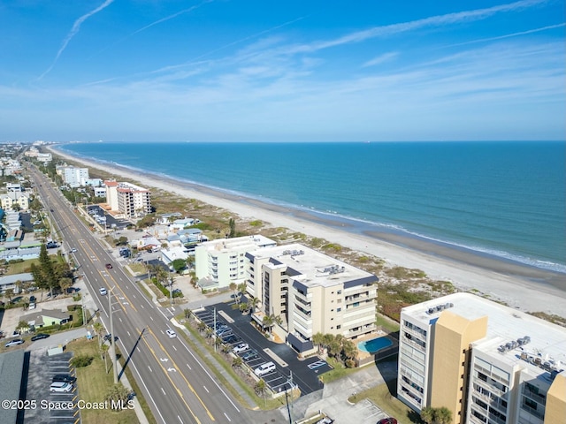 birds eye view of property with a view of the beach and a water view