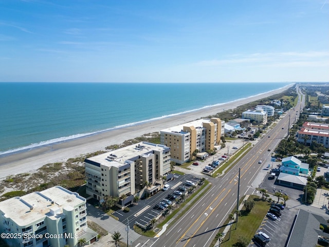 bird's eye view featuring a view of the beach and a water view