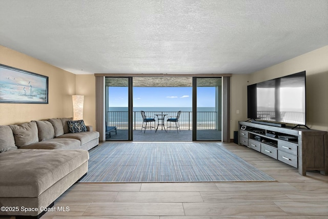 living room featuring floor to ceiling windows and a textured ceiling