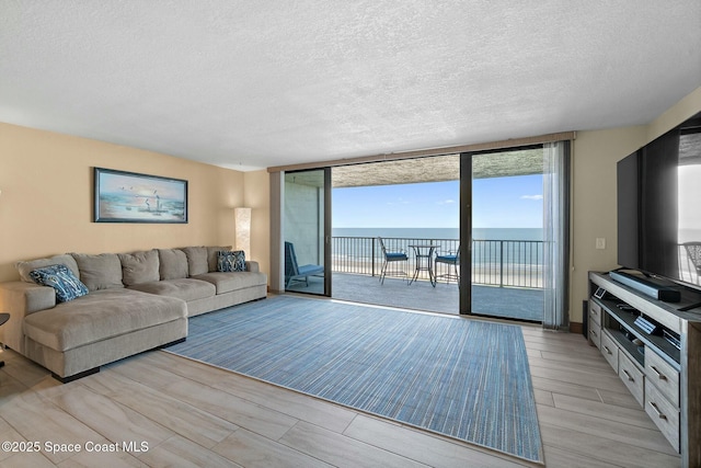 living room featuring floor to ceiling windows and a textured ceiling