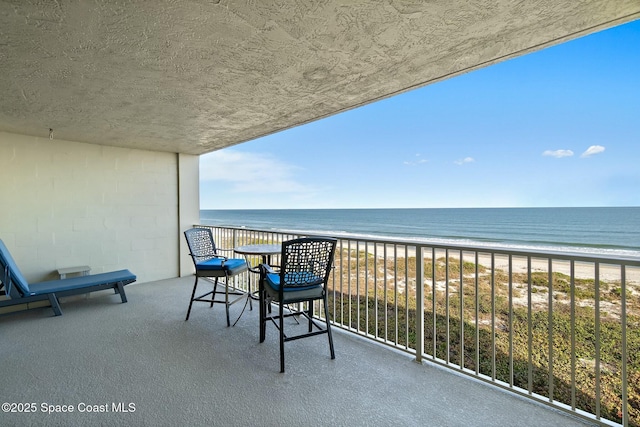 balcony with a view of the beach and a water view