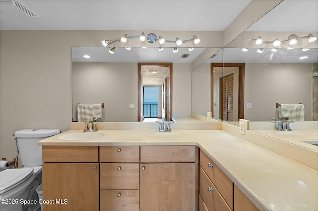 bathroom featuring vanity and toilet