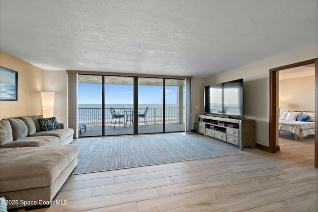 living room featuring expansive windows and a textured ceiling