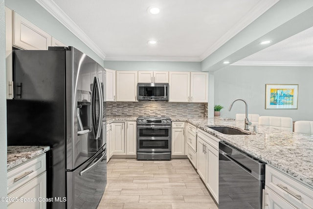 kitchen featuring sink, stainless steel appliances, tasteful backsplash, light stone countertops, and kitchen peninsula