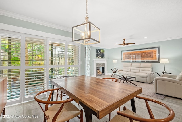 dining area with ceiling fan and ornamental molding