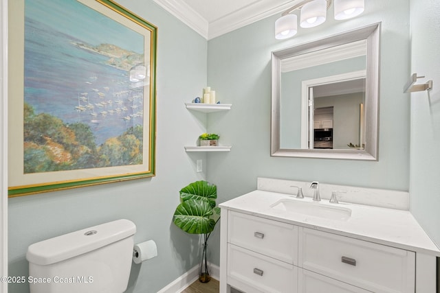 bathroom featuring crown molding, vanity, and toilet