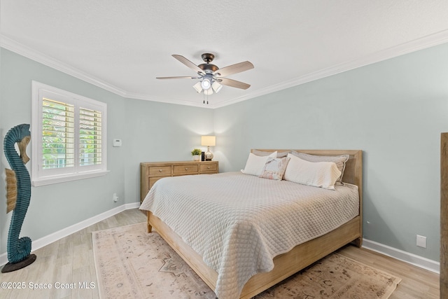 bedroom featuring crown molding, ceiling fan, and light hardwood / wood-style floors