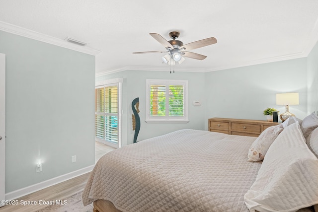 bedroom with crown molding, ceiling fan, and light hardwood / wood-style floors