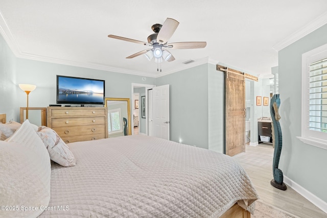 bedroom featuring ornamental molding, a barn door, ceiling fan, and light hardwood / wood-style flooring