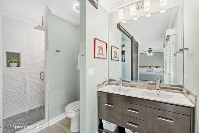 bathroom with walk in shower, toilet, ornamental molding, ceiling fan, and hardwood / wood-style floors