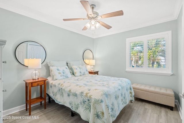 bedroom featuring ceiling fan, ornamental molding, and light hardwood / wood-style flooring