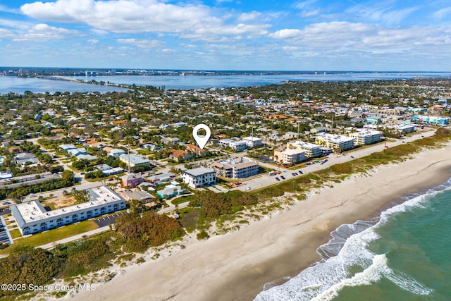 aerial view with a water view and a beach view