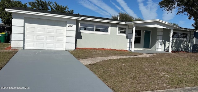 ranch-style house featuring a garage and a front lawn