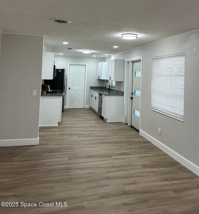 kitchen featuring dishwasher, white cabinetry, sink, dark hardwood / wood-style flooring, and ornamental molding