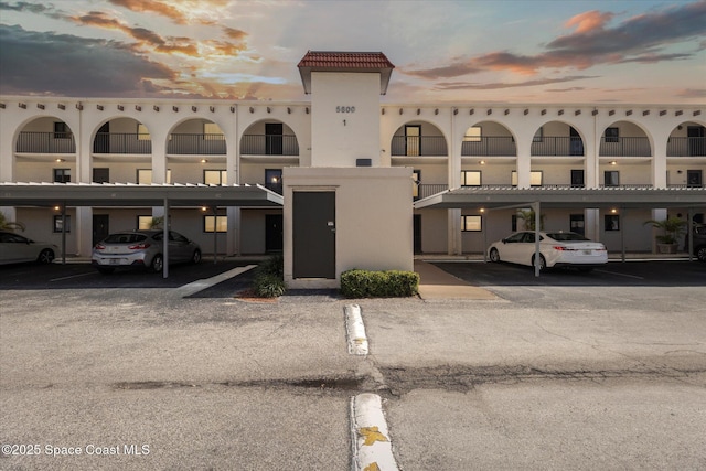 view of building exterior with covered parking