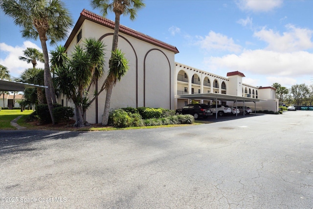 view of property featuring covered parking