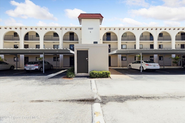 view of building exterior featuring covered parking